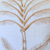 Close-up of embroidered palm tree design on fabric